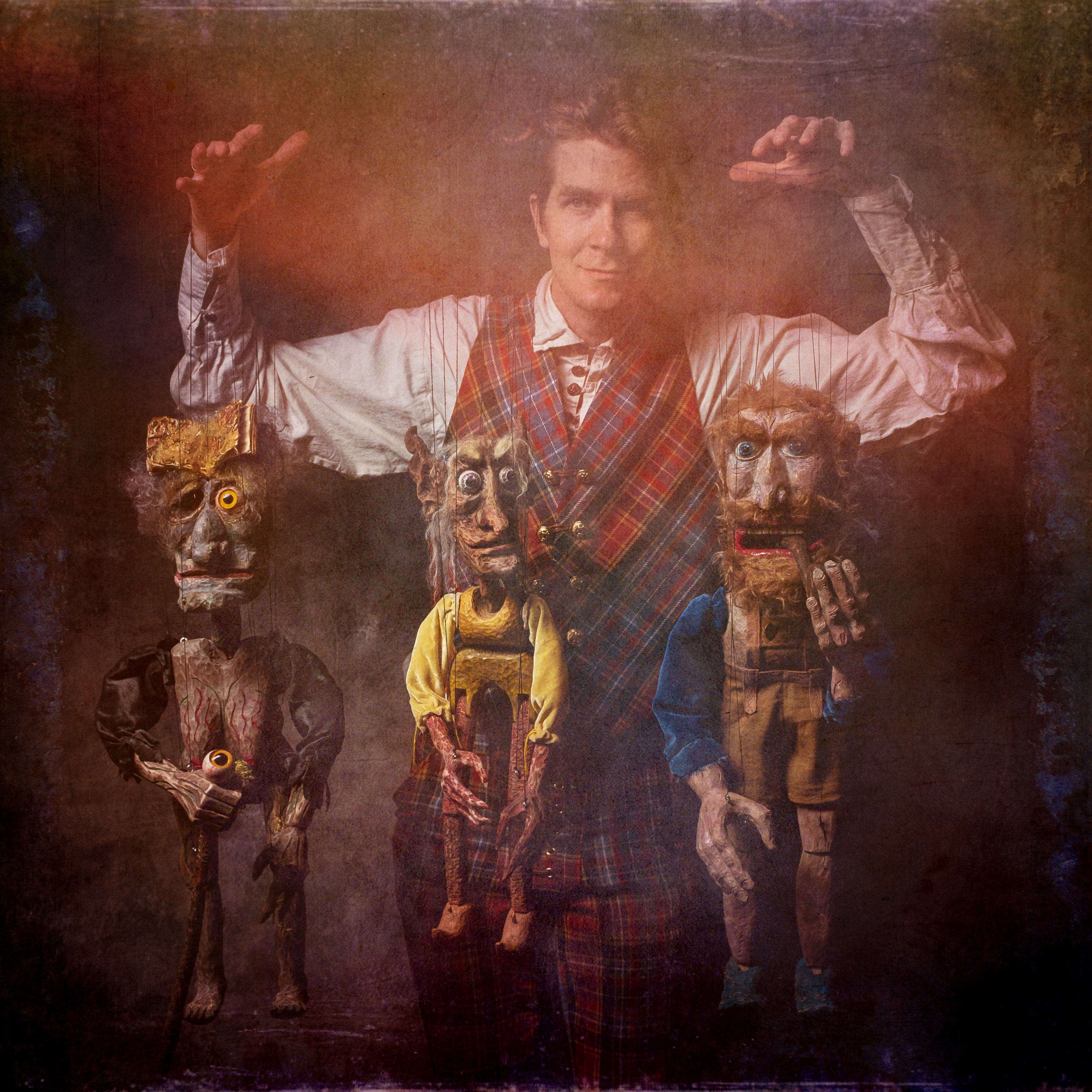 Storyteller-and-puppeteer-Dalrymple-MacAlpin-with-three-marionettes