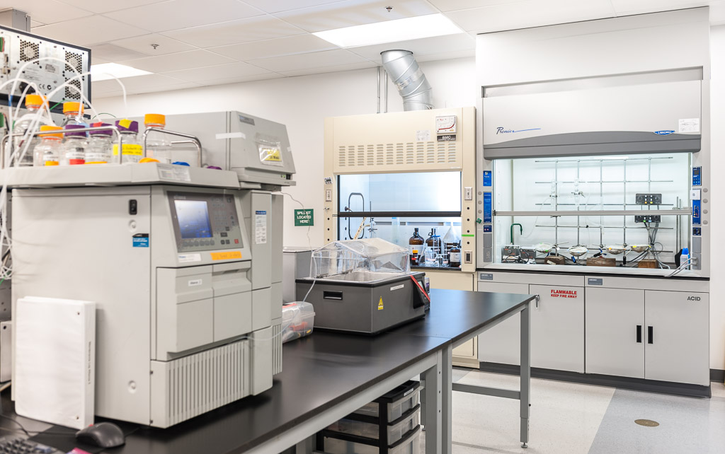 inside-alkemist-labs-testing-area-with-lab-equipment-including-ventiliation-hood-and-gas-chromatography-machine