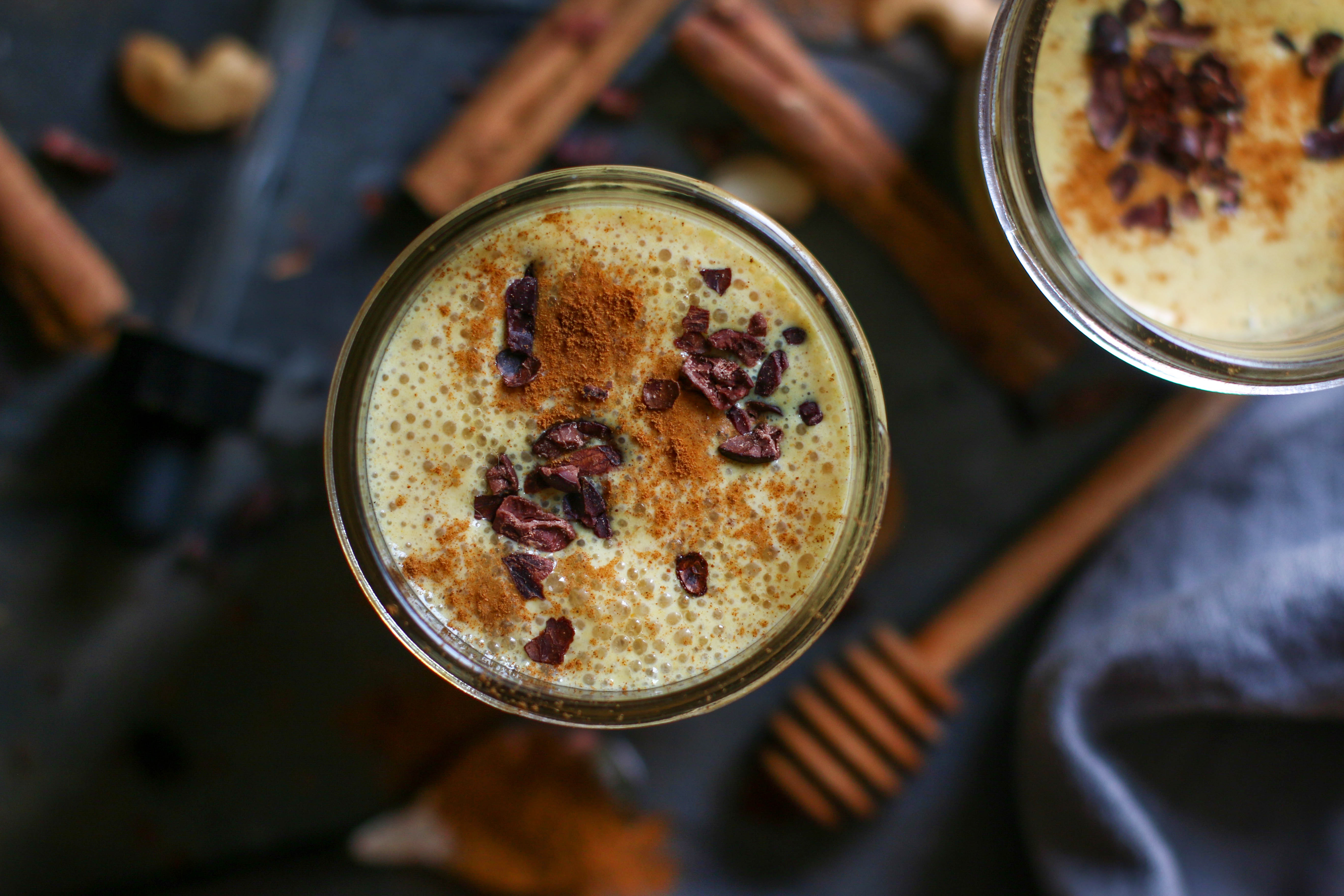 pumpkin-pie-smoothie-with-mushrooms-sprinkled-with-spices-in-canning-jar-with-honey-stick