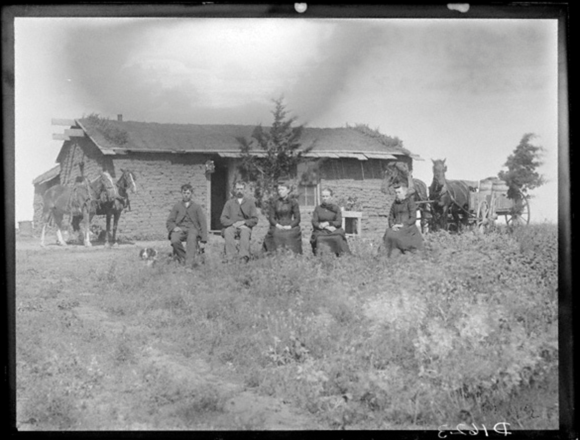 Frontier family in front of sod house
