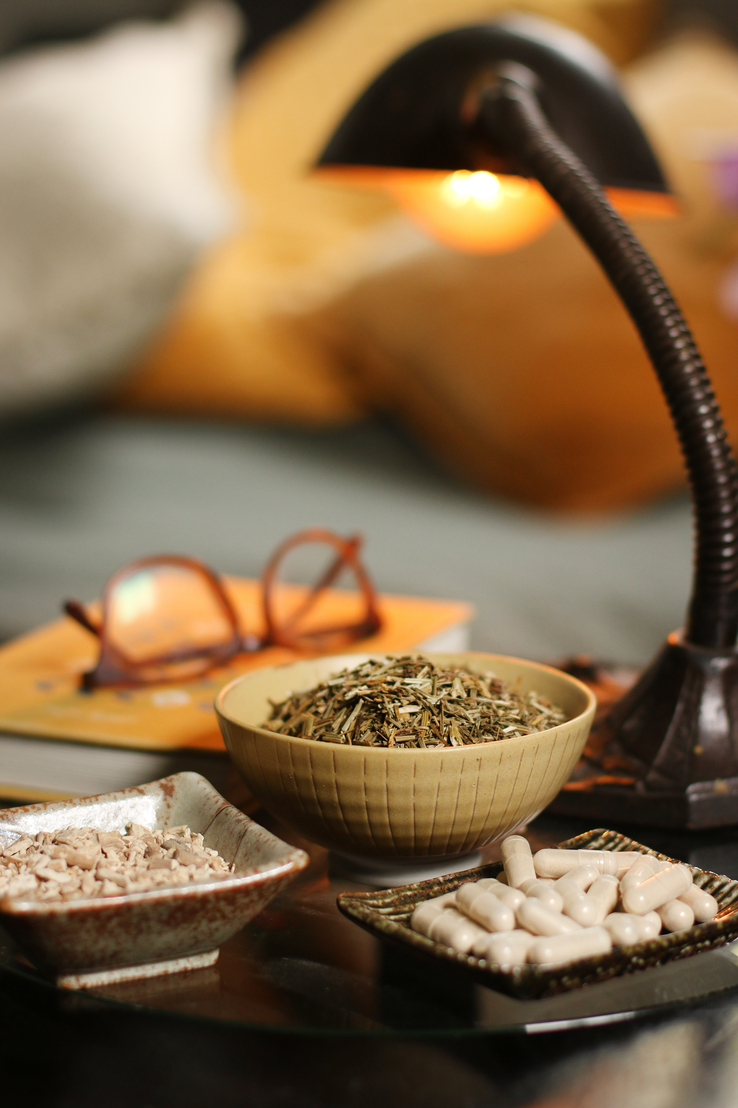 bedside-table-with-lamp-glasses-books-and-herbs-and-supplements-for-natural-sleep-support