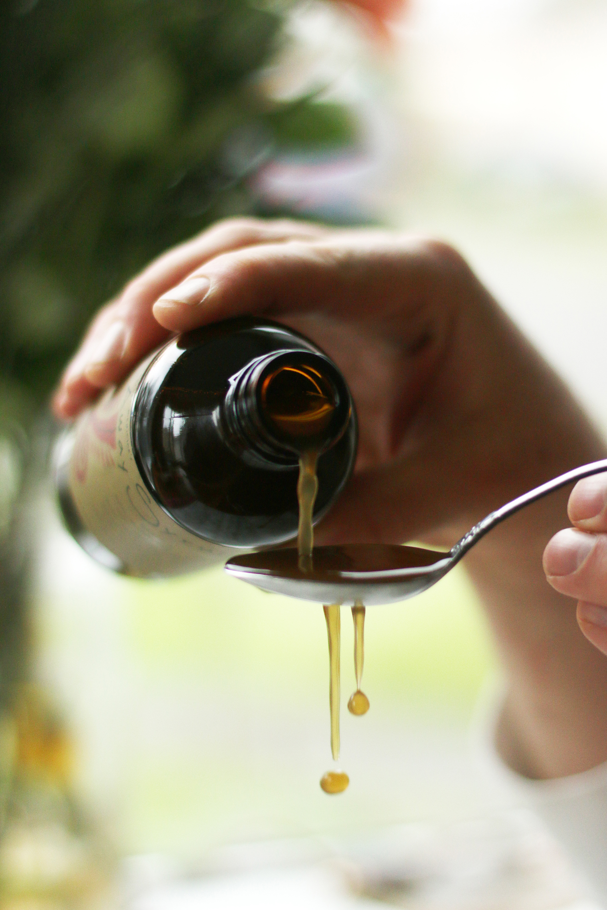 ashwagandha-syrup-being-poured-into-spoon-and-overflowing