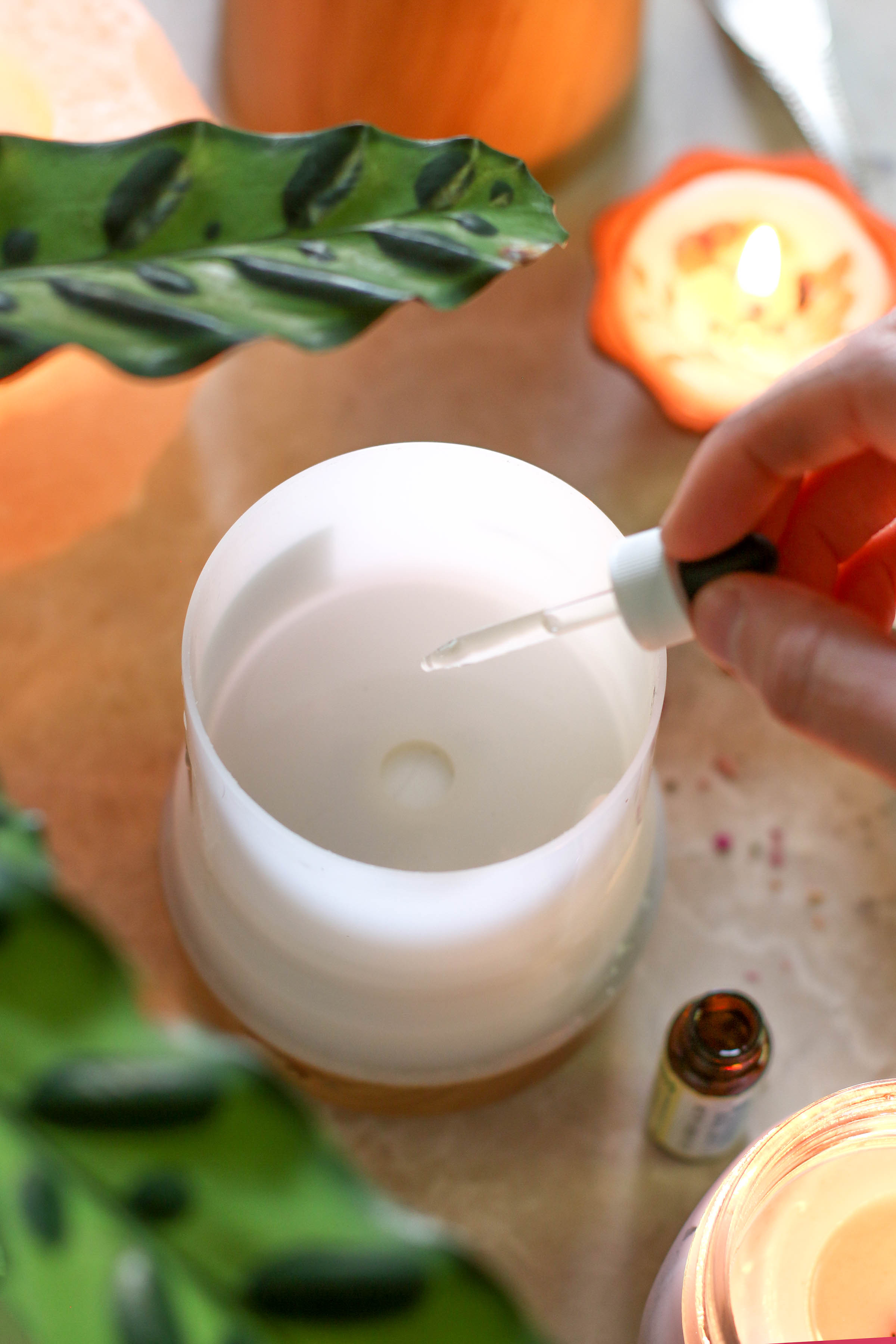 overhead-view-of-hand-dropping-essential-oil-into-diffuser