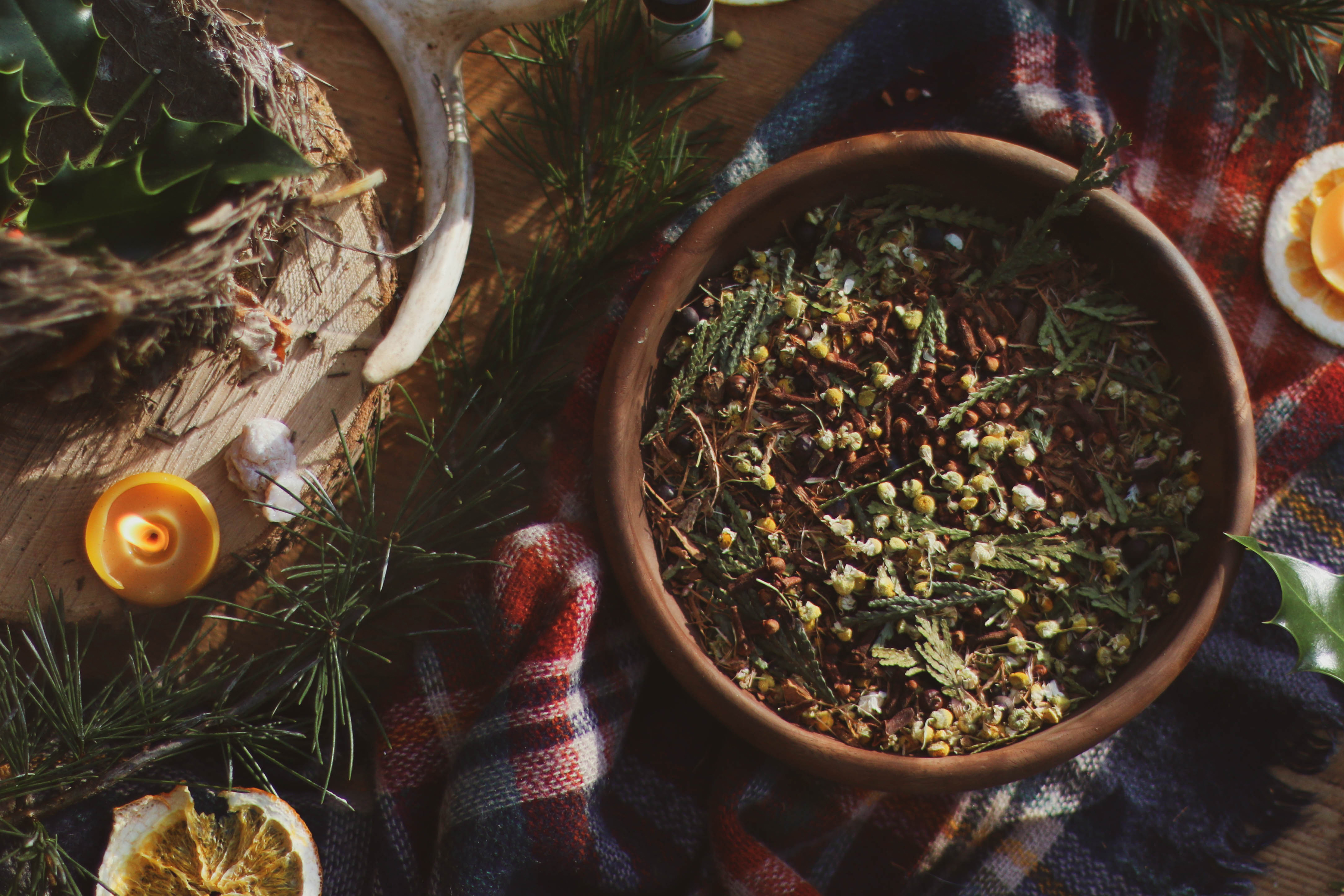 wooden-bowl-of-herbal-potpourri-blend-with-evergreens-and-yule-decorations